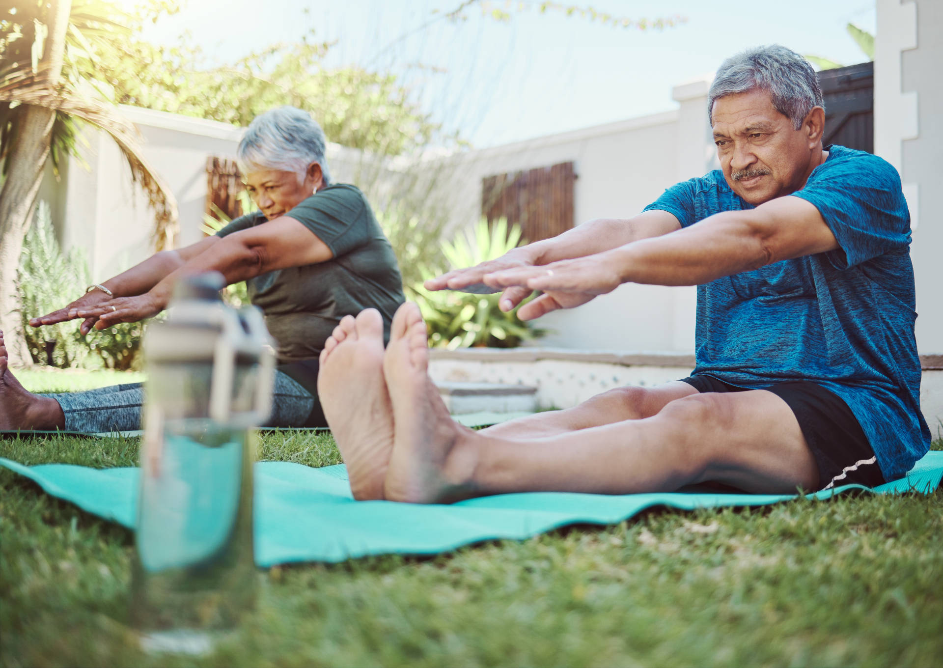 A senior couple stretching outdoors
