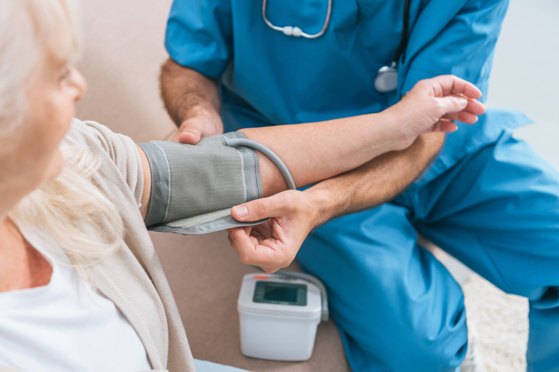 A woman has her blood pressure checked by a nurse